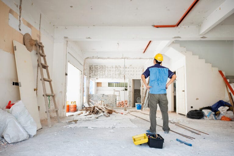 Construction worker inspecting home renovation site.